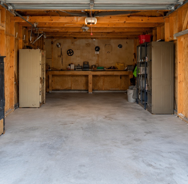 The same garage after Junk Dawgs cleared it: swept floor, empty walls